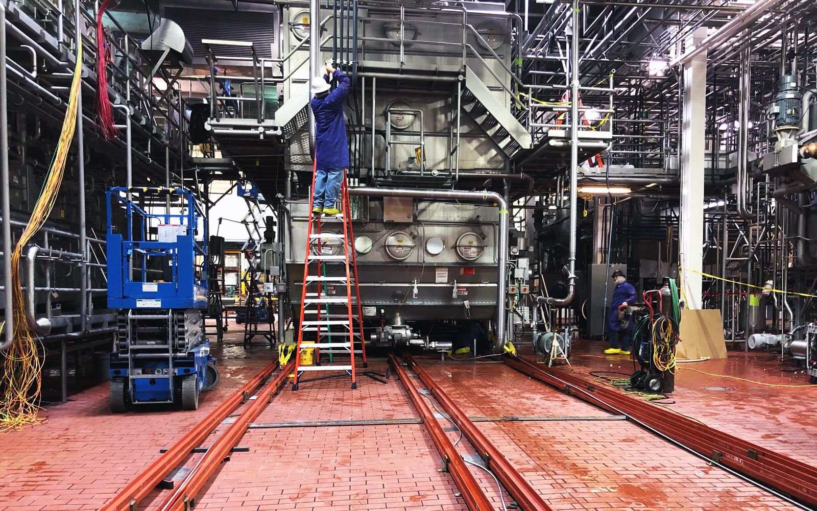 Installation crew working on a dryer in a dairy plant